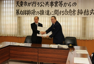 合意書を交わし握手する山本市長と鈴木天童警察署長